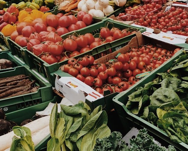 different vegetables on display and women standing near vegetable